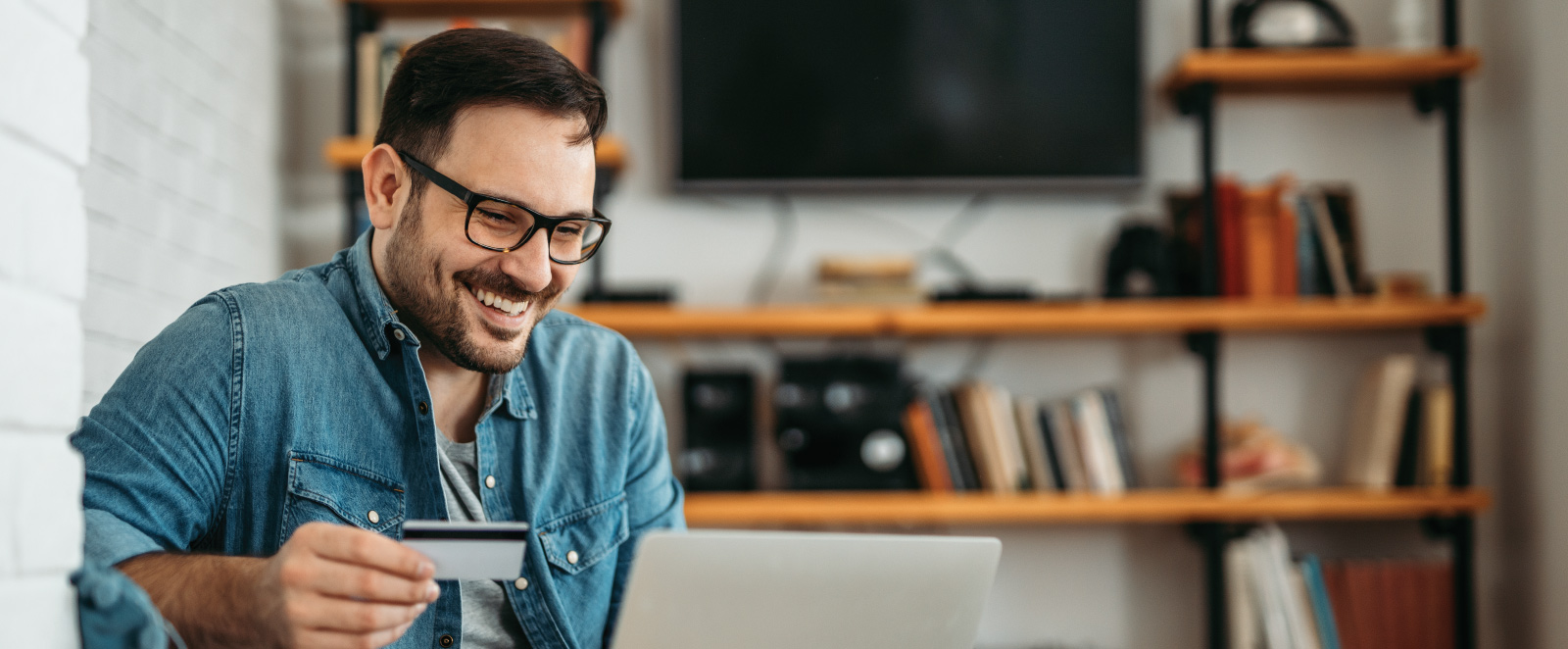 man using credit card for online purchases
