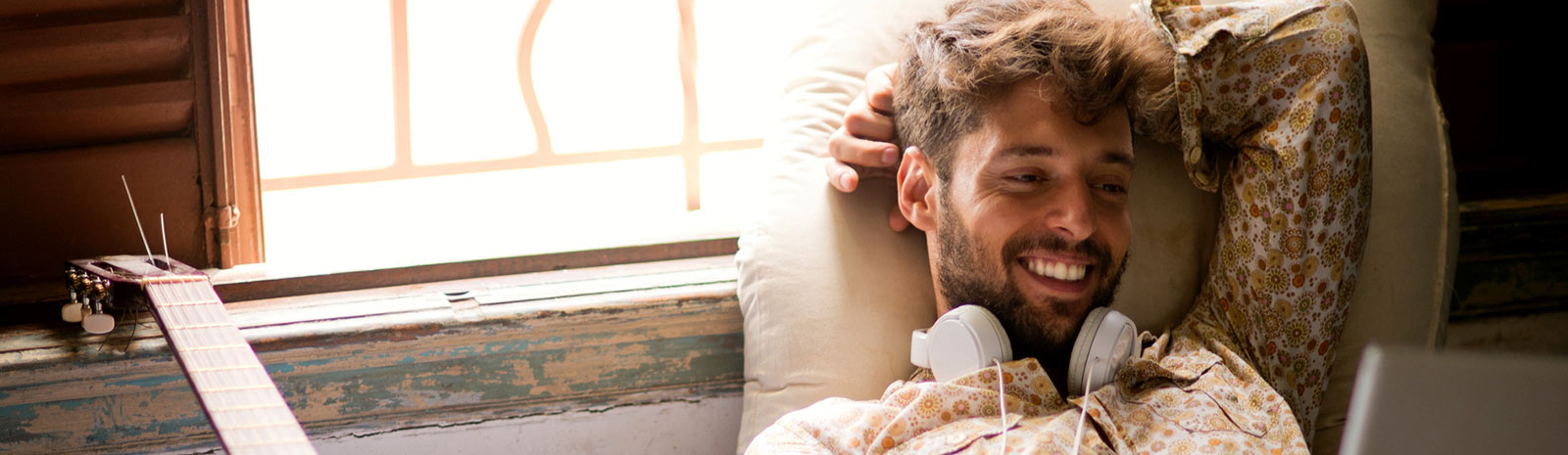 man on couch using laptop